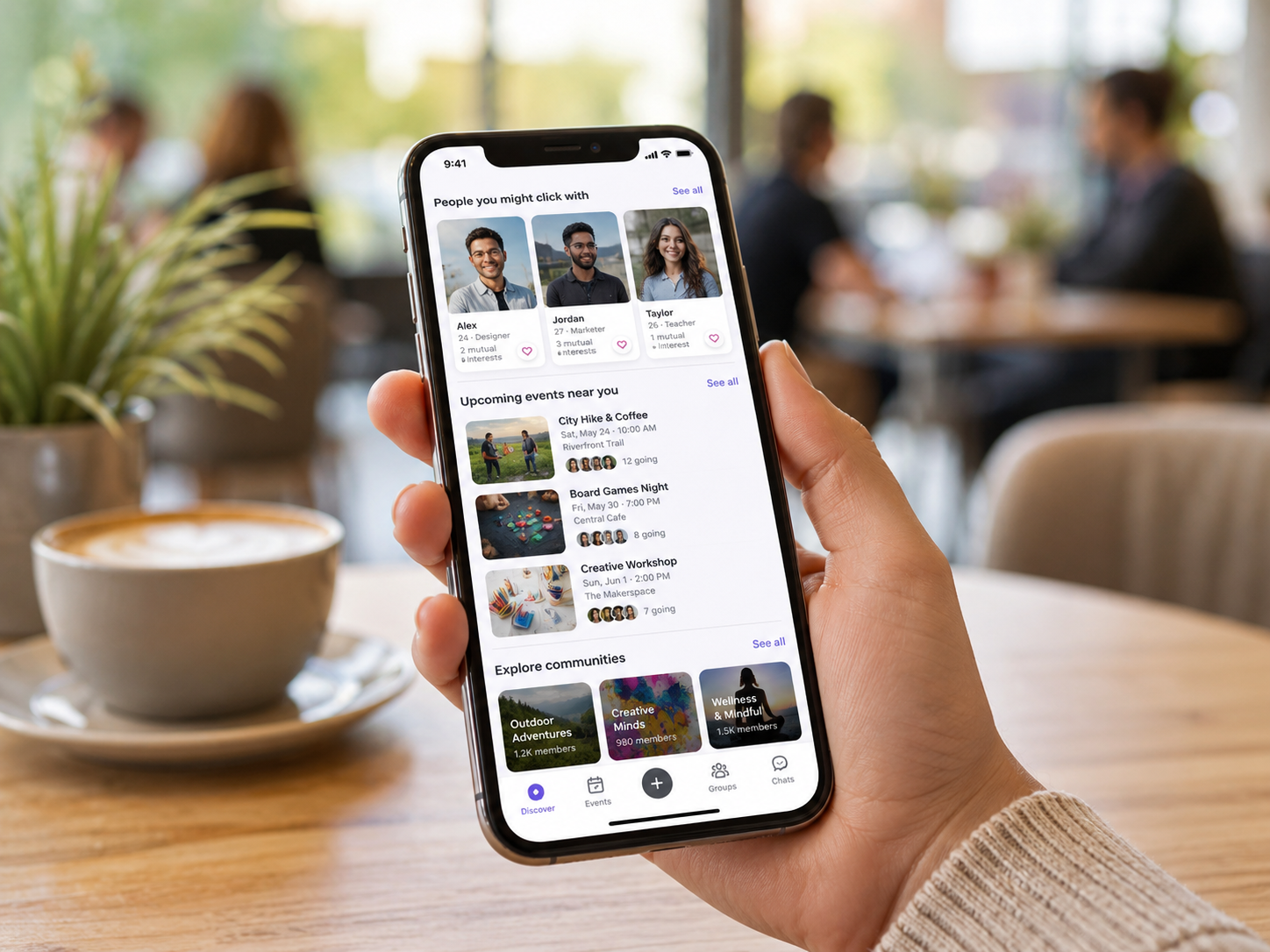 Friend-finding app shown on a phone in a cozy cafe